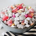 muddy buddies with valentines candy in a large bowl