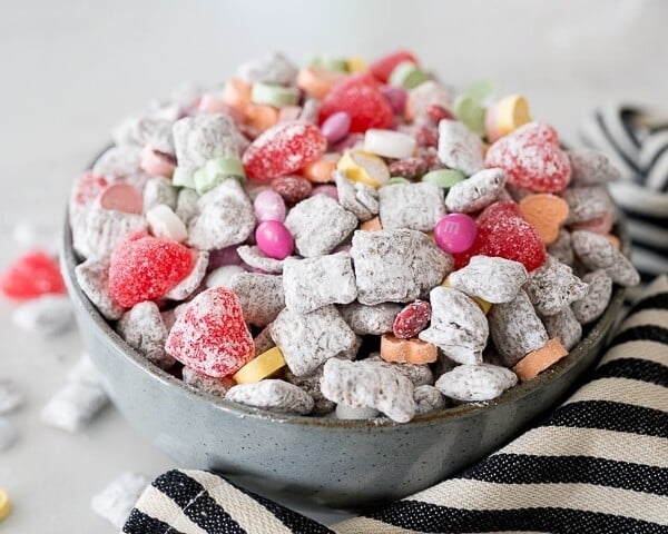 muddy buddies with valentines candy in a large bowl