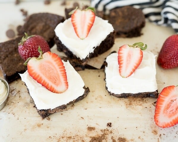 chocolate brownies with cream cheese frosting and strawberries on top