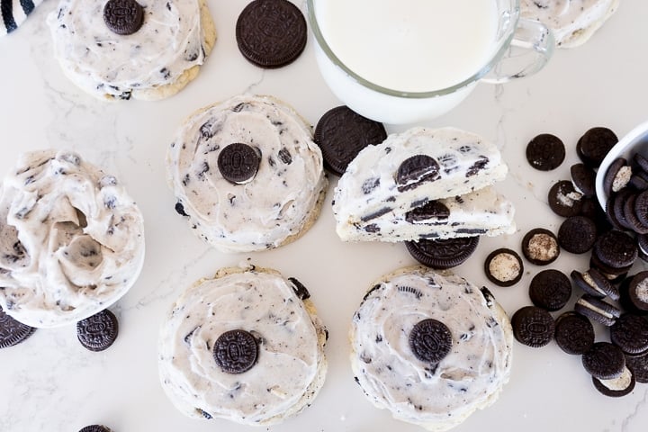 Cookies and cream milkshake cookies with mini Oreos, a glass of milk and cookies and cream icing