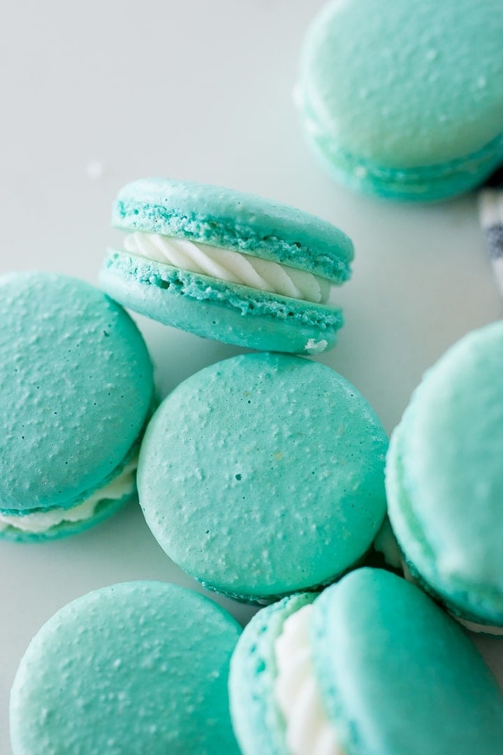 blue macarons with white filling, on a white background