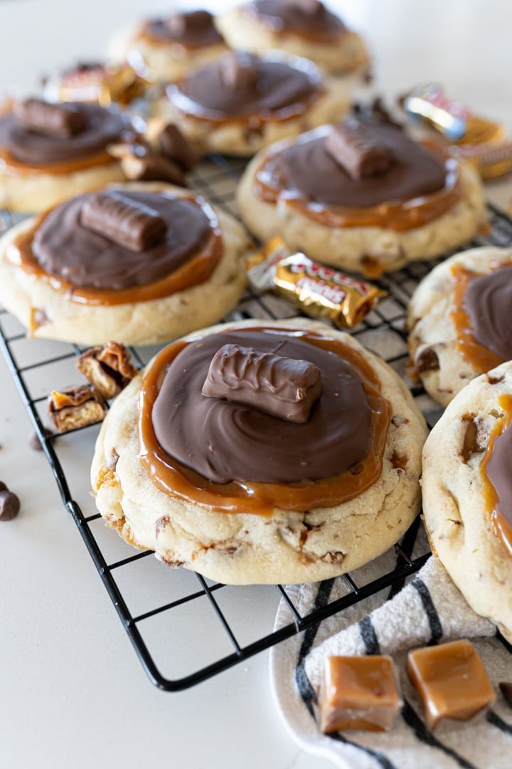 crumbl Twix cookies on a cookie cooling rack