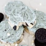Aggie blue mint cookie sitting on top of two other cookies