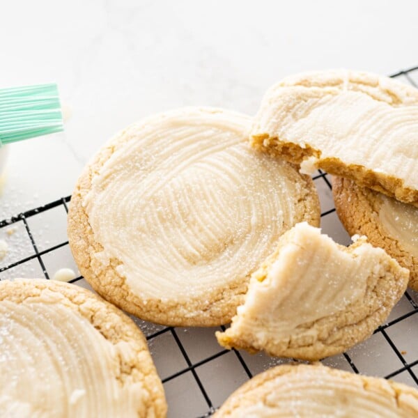featured image for Kentucky butter cake. cookies on a black cooling rack, stacked on top of each other.