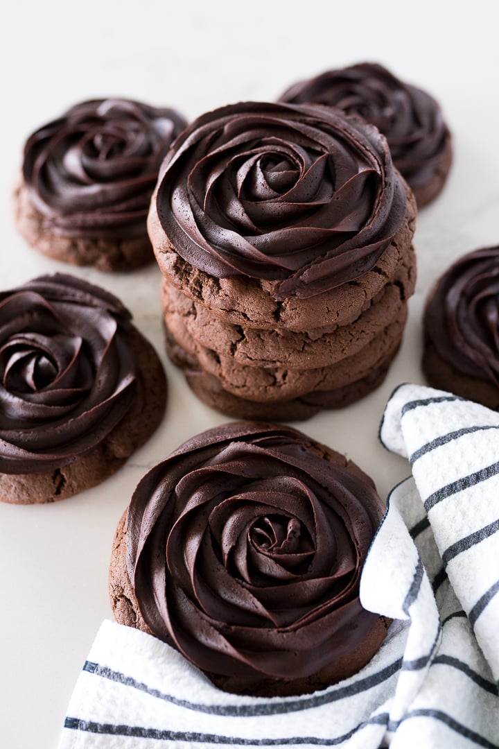 chocolate cookie with chocolate fudge frosting on top in a rose looking swirl.
