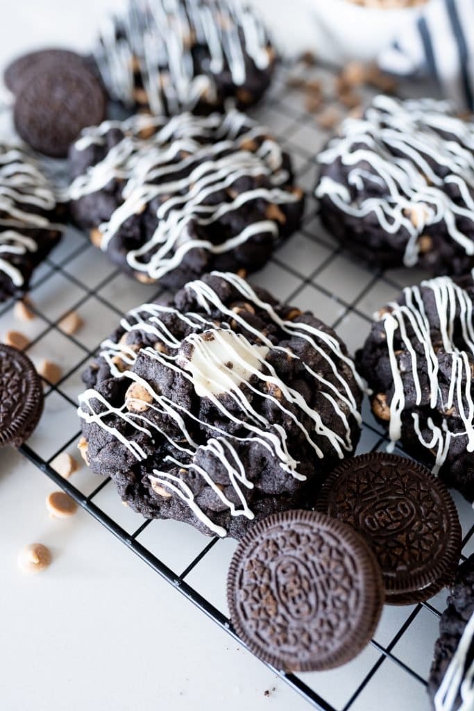 Peanut butter oreo cookies on a cookie cooling rack