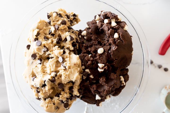 Chocolate chip cookie dough and triple chocolate cookie dough in the same bowl.