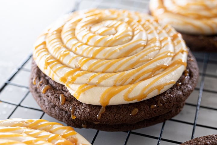 chocolate cookie with caramel cheesecake on top with a drizzle of caramel