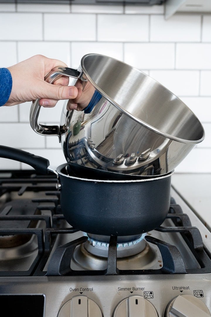 stand mixer bowl on a small sauce pan on the stove top