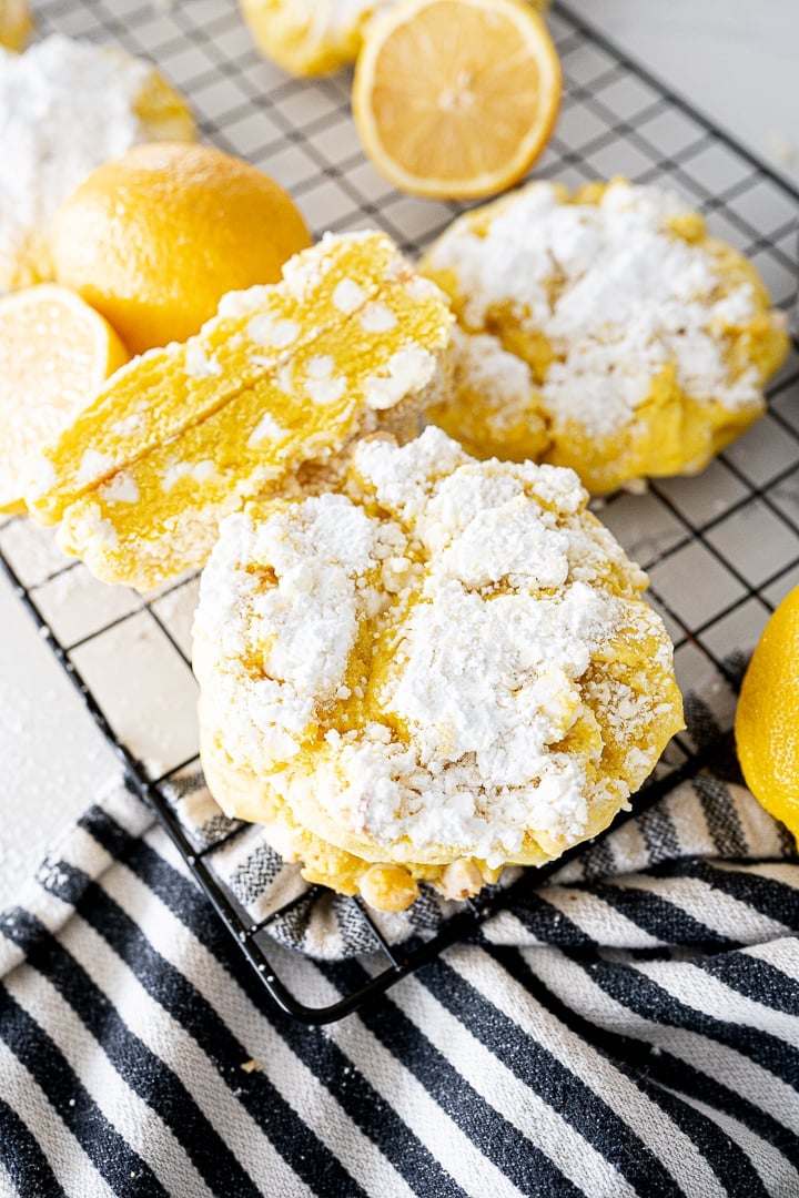 Lemon cookie on a cookie cooling rack with powdered sugar on top.