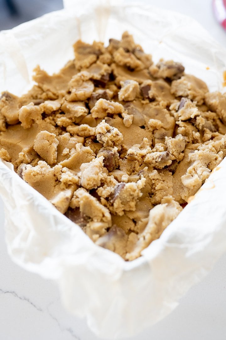 caramel chocolate chip cookie bars in the pan before baking