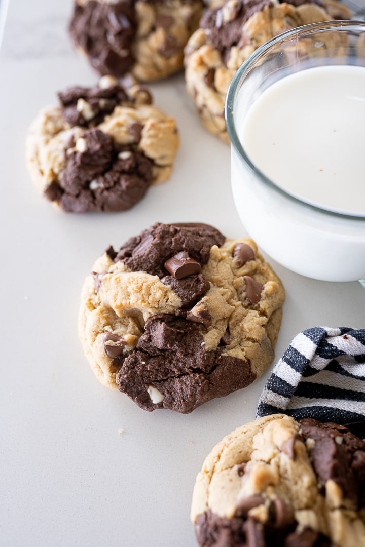 brookies recipe with half brownie half chocolate chip cookie next to a glass of milk