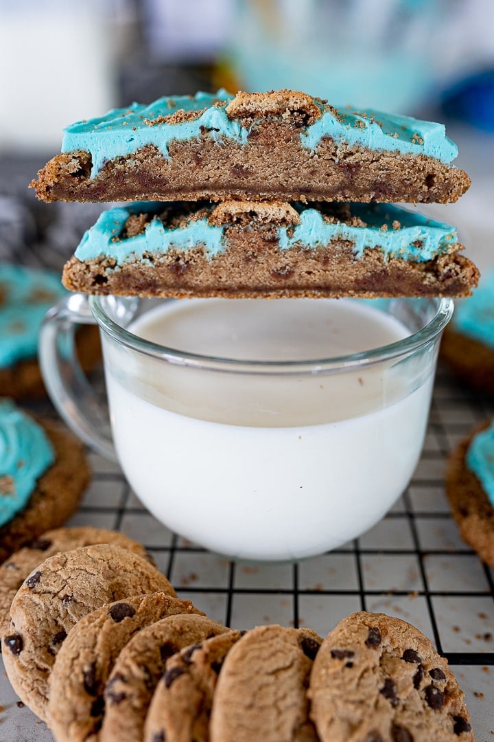 Cookie Monster chips ahoy cookie cut in half on top of a glass of milk