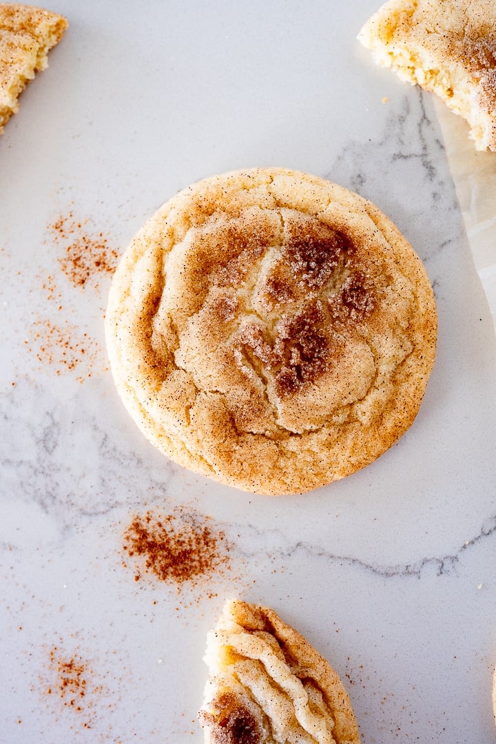 snickerdoodle cookies on the counter with cinnamon by it