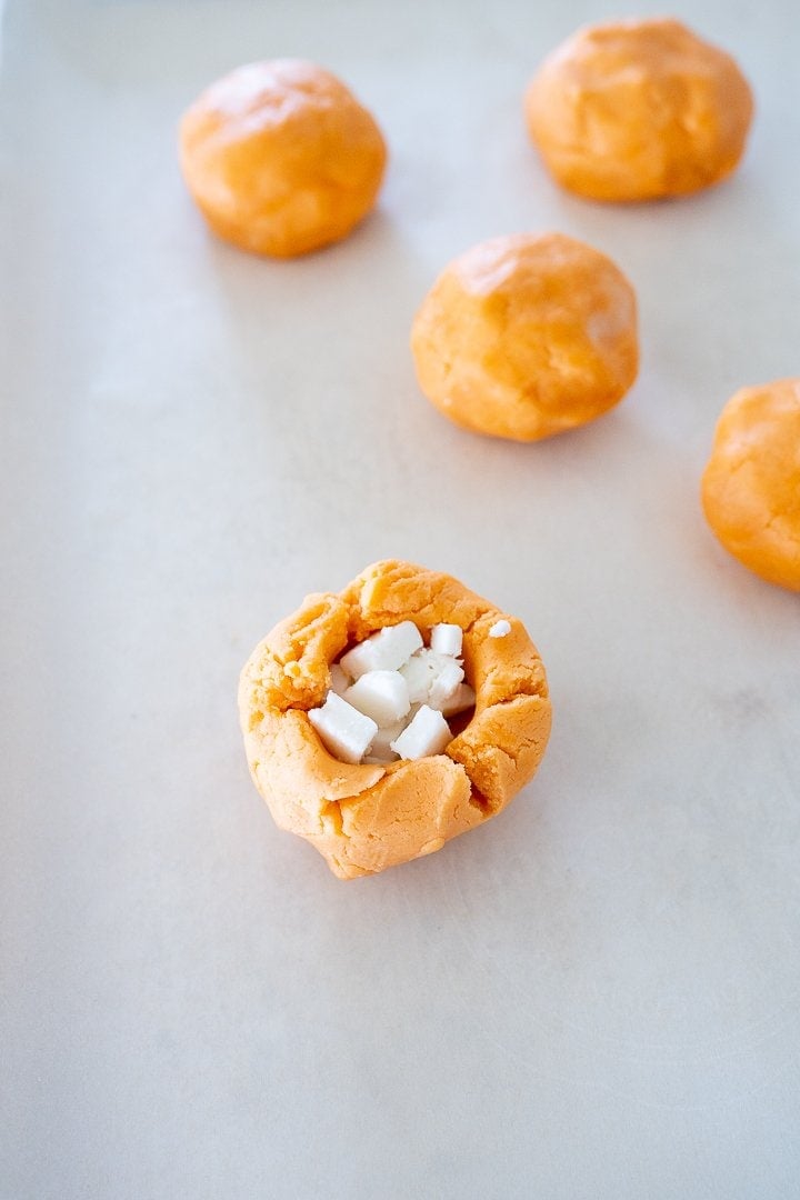 Orange Creamsicle cookies before they are baked with vanilla buttercream in the center