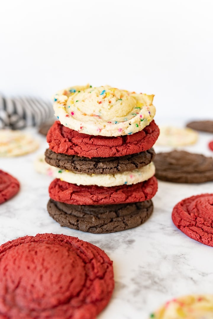 different flavors of cake mix cookies stacked on top of each other. 