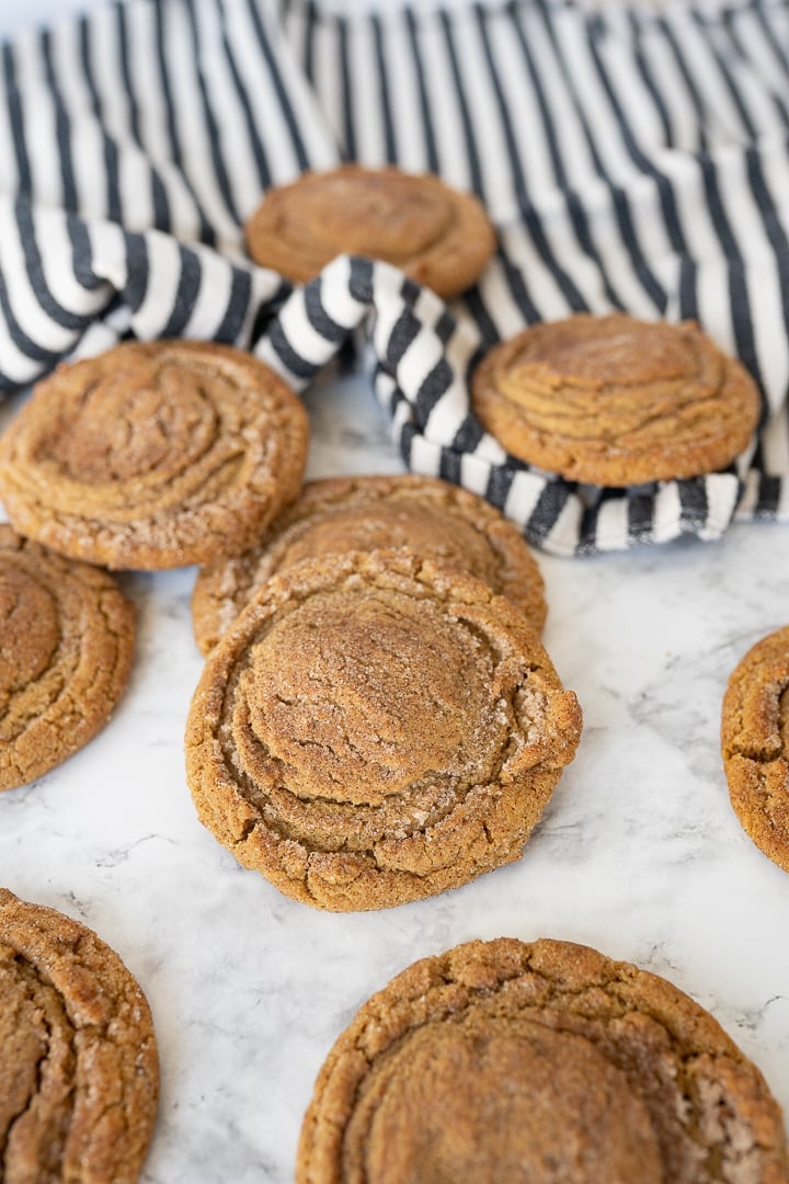 gingersnap cookies on the counter with a striped towel