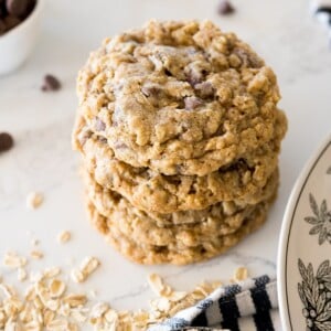 hearty oatmeal chocolate chip cookies on the counter stacked on top of each other.