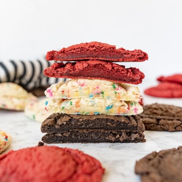 different kinds of cake mix cookie scut in half and stacked on top of each other.
