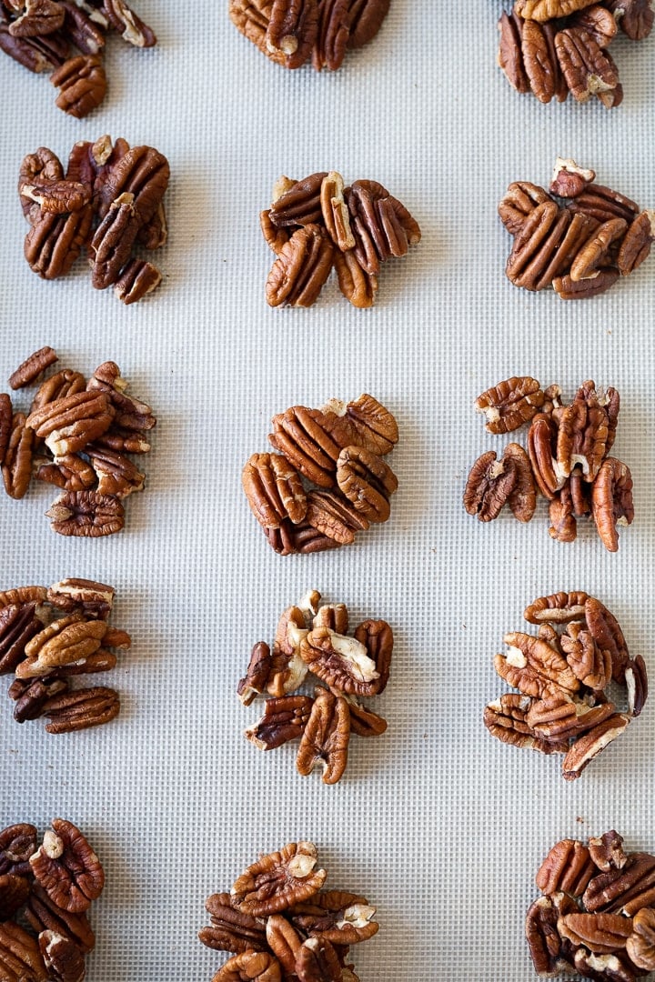 pecan piles on a silicone lined cookie sheet.