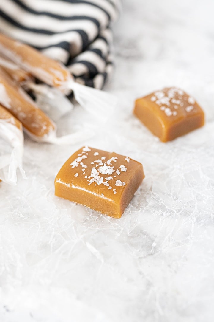caramel square on the counter with sea salt on top.