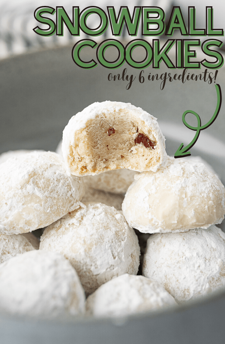 A bowl of snowball cookies with a bite taken out of one of them and green writing on the photo that reads "Snowball Cookies, Only 6 Ingredients."