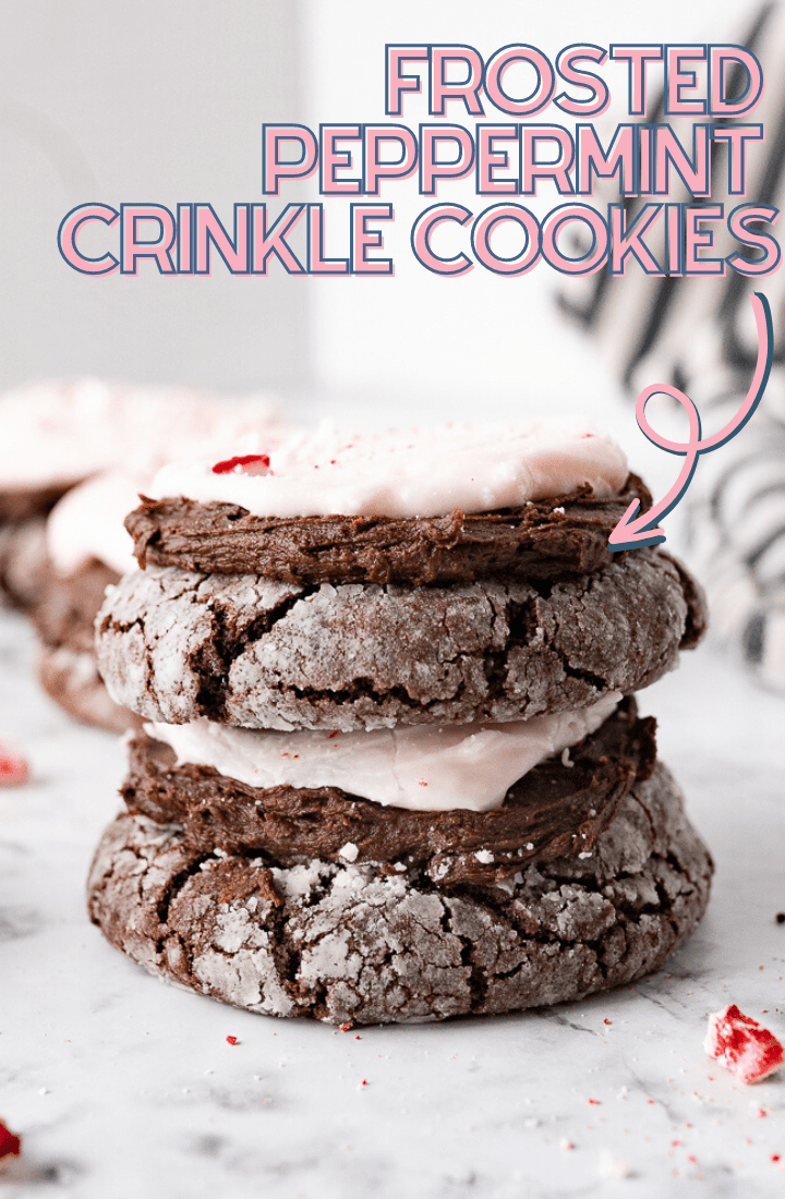 Two chocolate peppermint crinkle cookies stacked on top of each other on the counter.