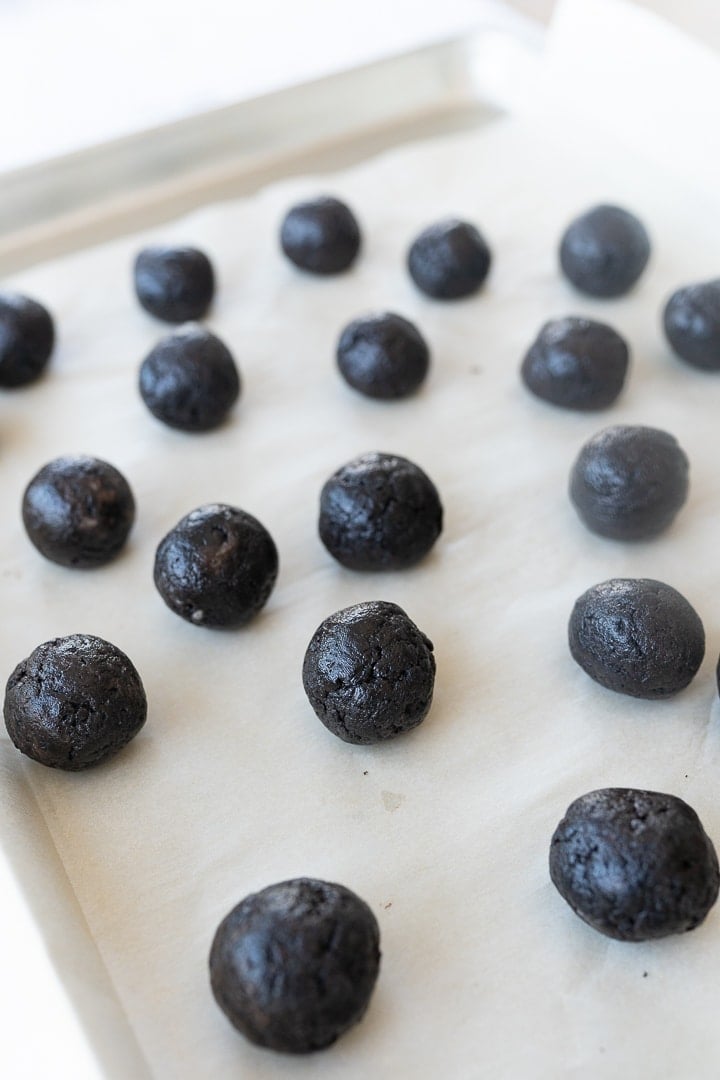 Oreo truffles rolled into balls on a cookie sheet, but not covered in white chocolate yet.