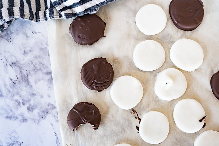 homemade peppermint patties on the counter on some parchment paper. 