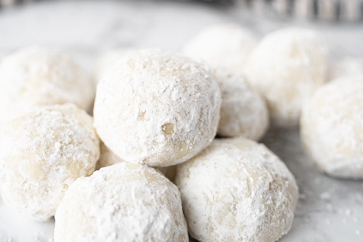 A pile of Snowball cookies on the counter.