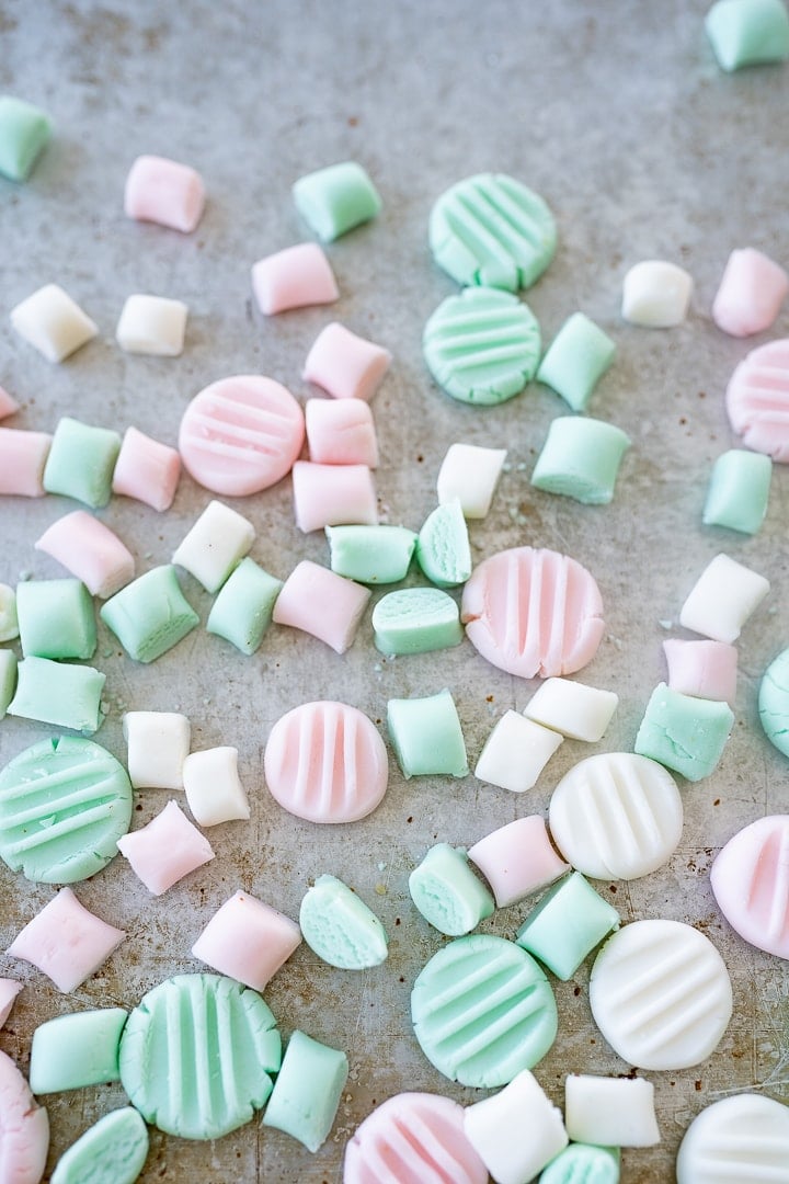 Cream cheese mints in various decorative shapes laying on the counter.