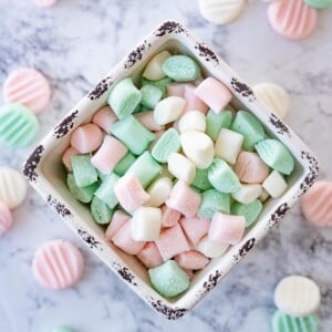 A bowl of red, white, and green cream cheese mints.