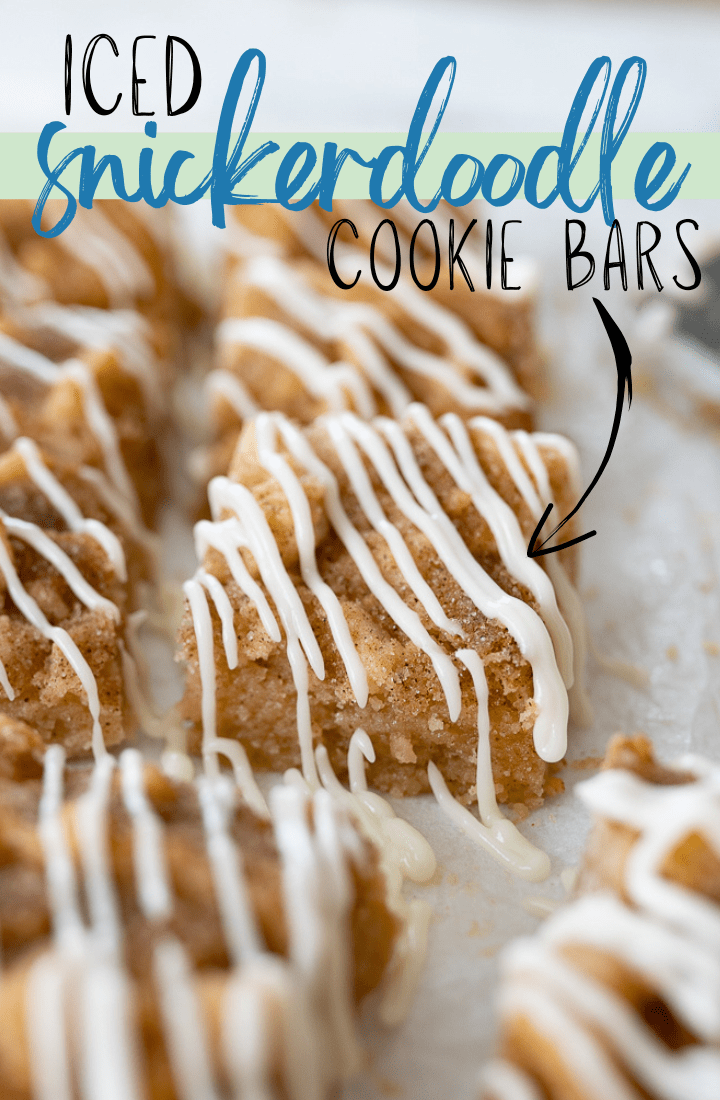 Snickerdoodle bars covered in icing with text on the photo that reads "iced snickerdoodle cookie bars."
