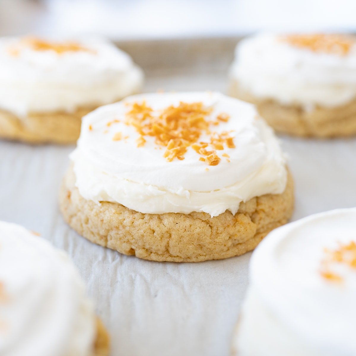 Coconut Cream Pie Cookies on parchment paper on the counter.