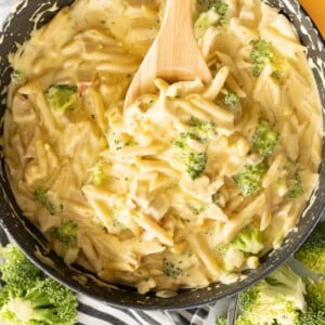 Chicken, broccoli and pasta in a cheese sauce in a pan on the counter.