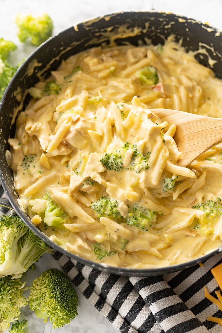 Chicken, pasta and broccoli in a cheese sauce in a large pan. 