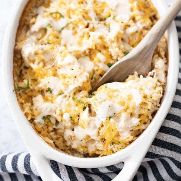 Chicken and Rice Bake in a casserole dish on the counter with a serving spoon.