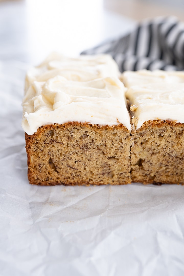 banana cake with brown butter cream cheese frosting, cut into squares.