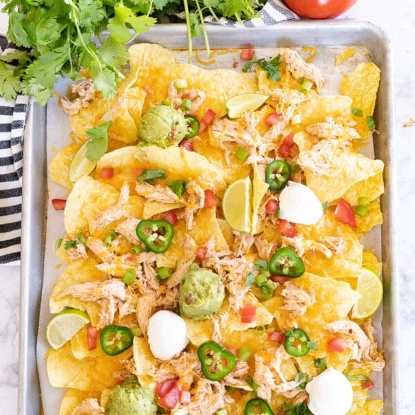 Sheet pan chicken nachos with all the toppings.
