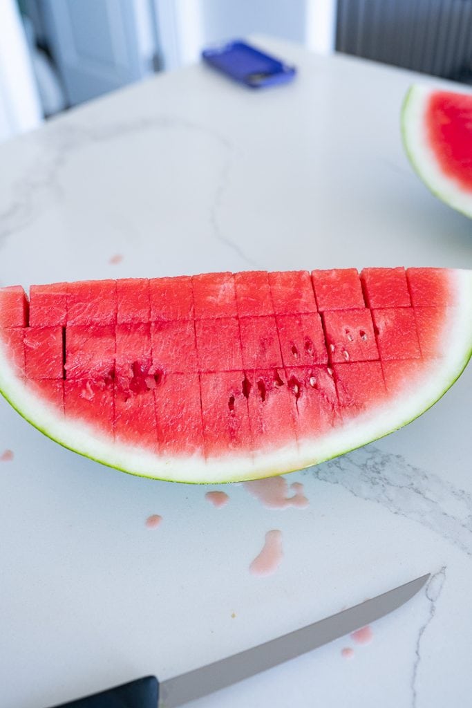Steps how to cut a watermelon, turn watermelon and slice again.