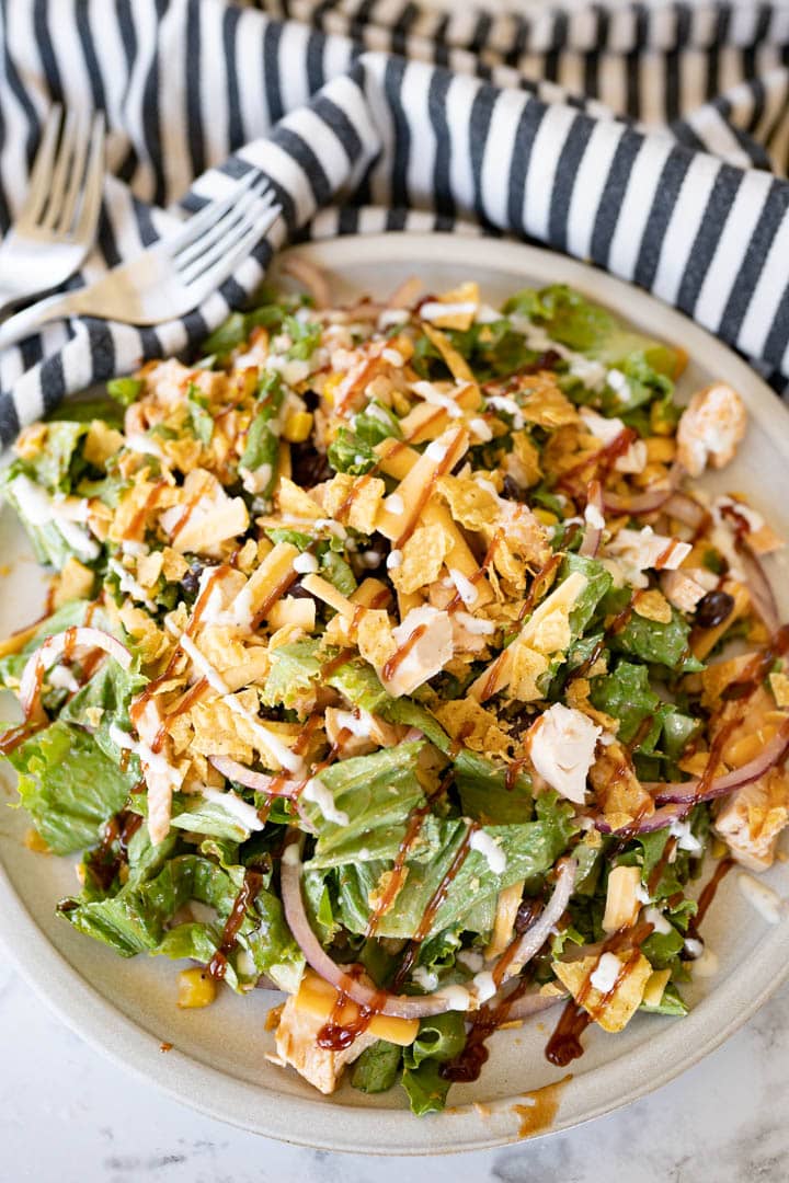 A serving bowl of mixed up bbq ranch chicken salad. 