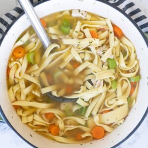 Aerial view of a bowl of chicken noodle soup.
