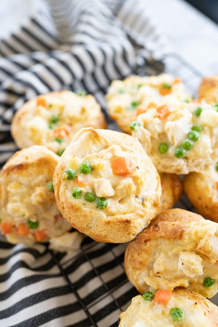 A close up of a pile of mini chicken pot pies. 