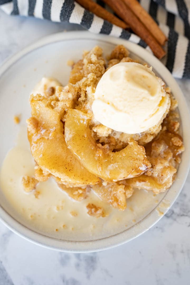 Aerial view of apple crisp without oats topped with melty ice cream.