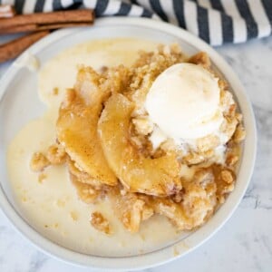 Aerial view of apple crisp without oats topped with melty ice cream.