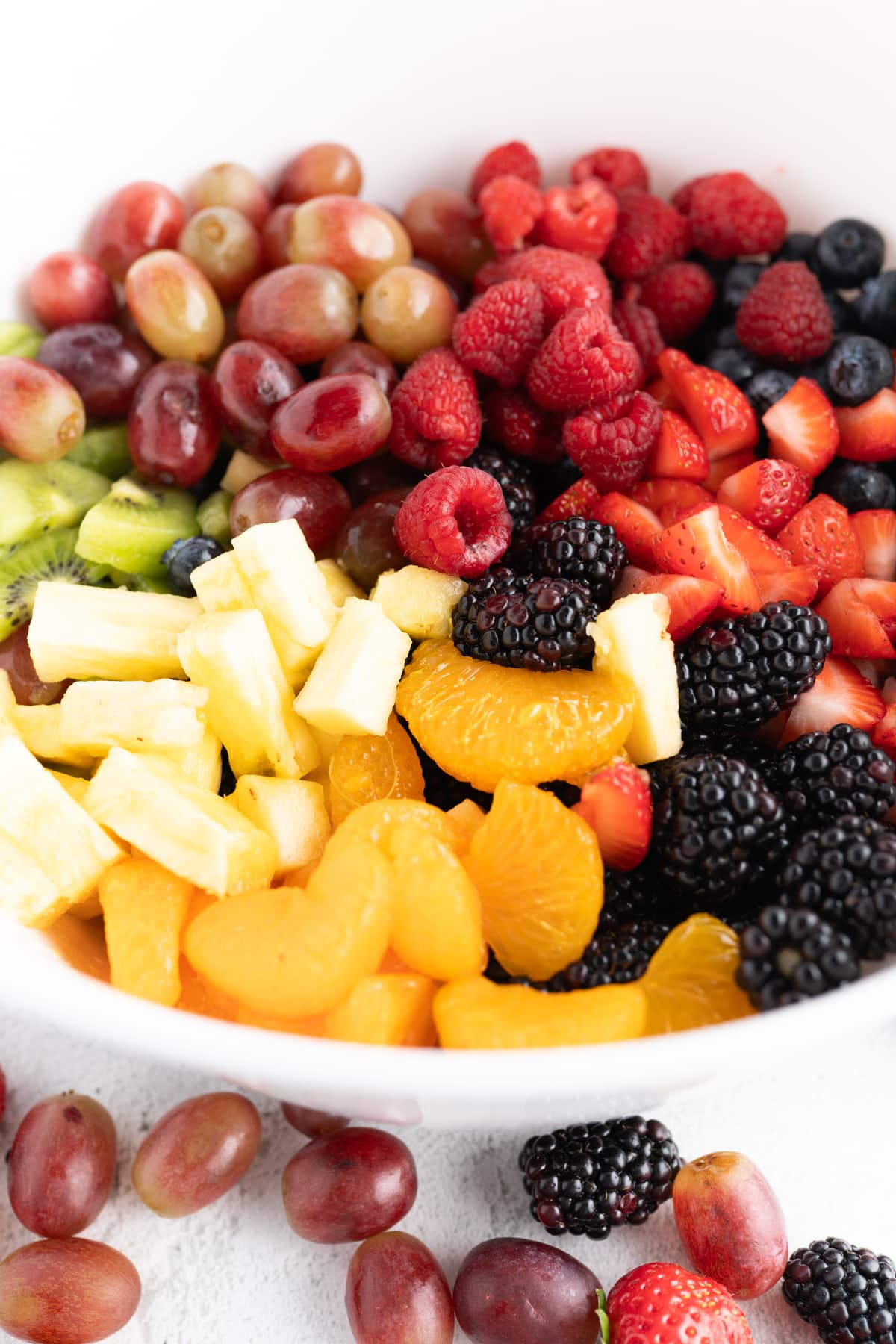 Side view of chopped fruit in a bowl to make this recipe for fruit salad. 