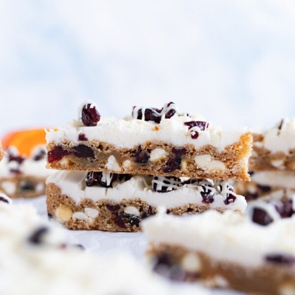 Cranberry bliss bars stacked on top of each other.