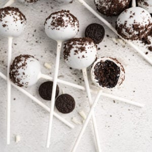 Aerial view of cookies and cream cake pops (starbucks) arranged on the counter with oreos.