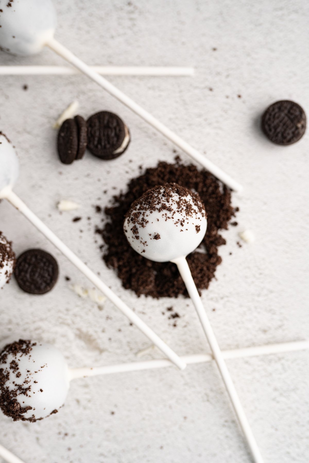 Image of a starbucks cookies and cream cake pop rolling in crushed oreos. 