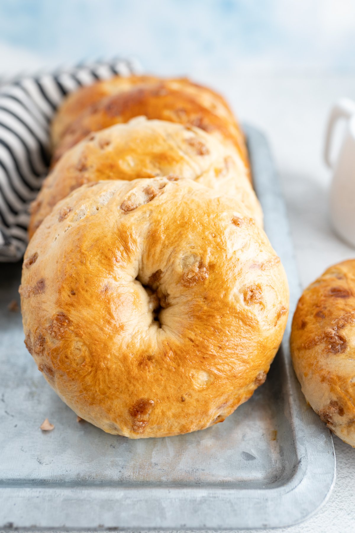 A horizontal stack of cinnamon french toast bagels. 